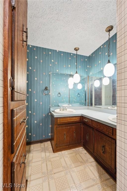 bathroom with vanity and a textured ceiling