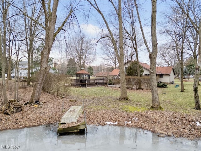 view of yard featuring a gazebo and a water view