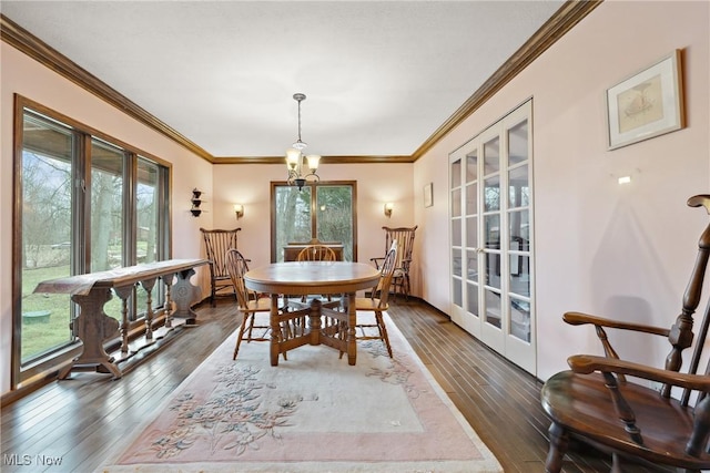 dining space with dark wood-type flooring and ornamental molding