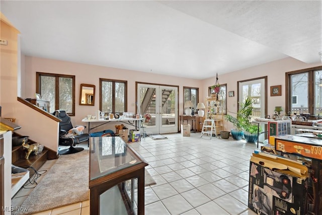 living room featuring french doors and light tile patterned floors