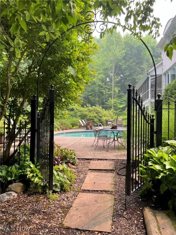 exterior space featuring a fenced in pool and a patio area