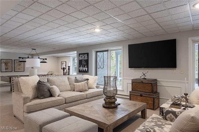 carpeted living room with a baseboard heating unit