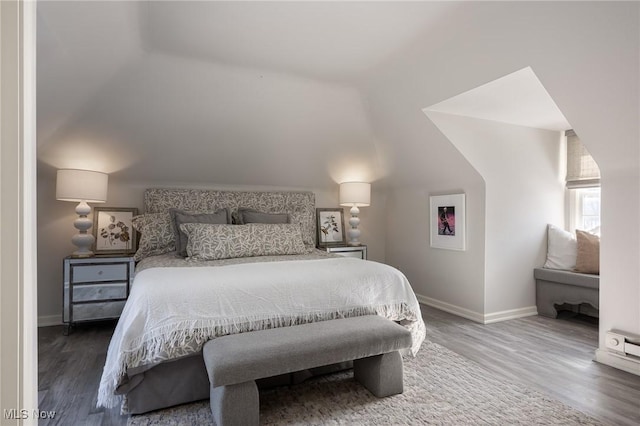 bedroom featuring lofted ceiling and hardwood / wood-style floors