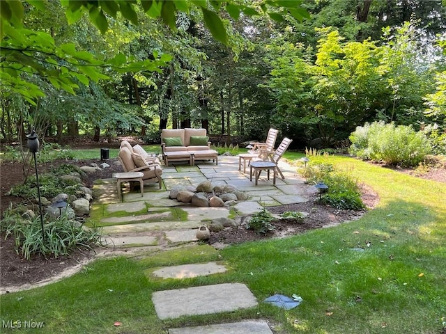 view of yard with an outdoor living space and a patio area