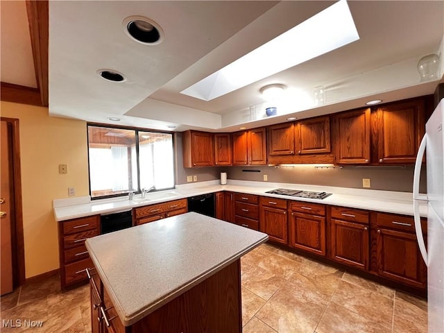 kitchen featuring stainless steel gas cooktop, a skylight, a center island, white refrigerator, and black dishwasher