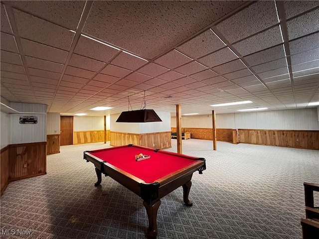 game room with a drop ceiling, wooden walls, and carpet