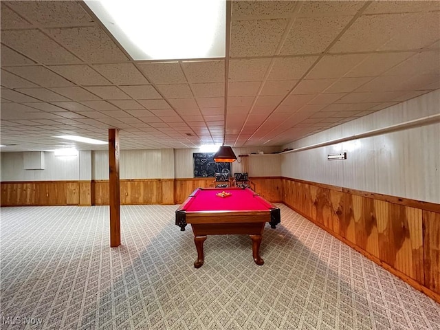 game room featuring pool table, carpet flooring, a drop ceiling, and wood walls