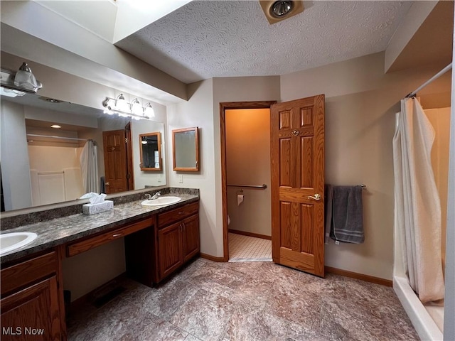 bathroom with vanity, a textured ceiling, and a shower with shower curtain