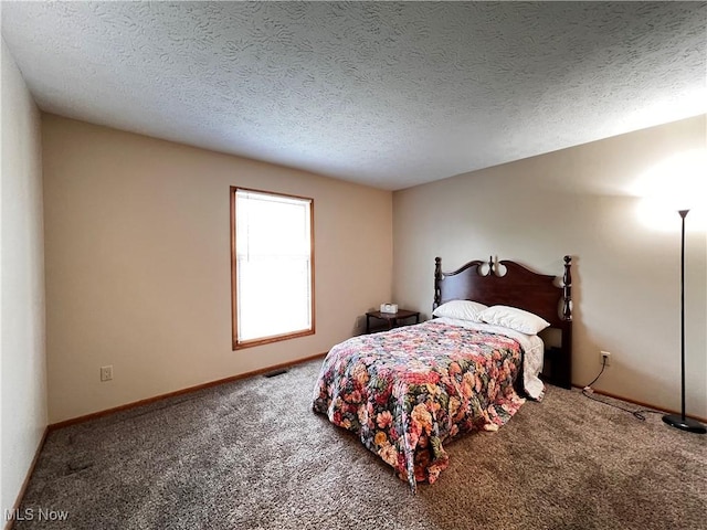 bedroom featuring carpet floors and a textured ceiling