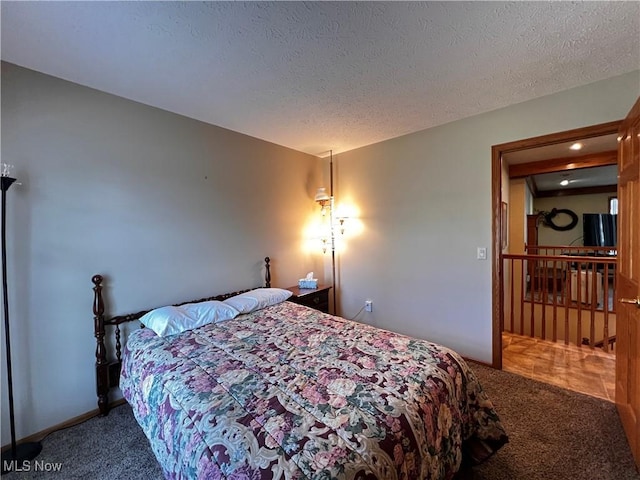 carpeted bedroom with a textured ceiling