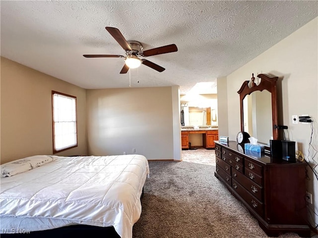 carpeted bedroom with a textured ceiling, ceiling fan, and ensuite bathroom