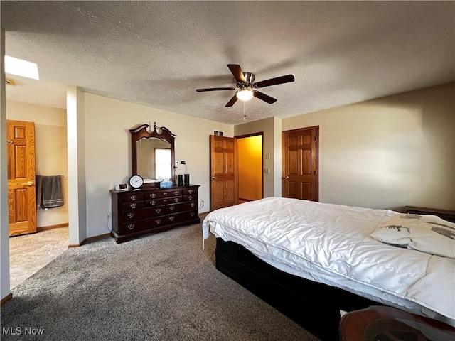 carpeted bedroom with ceiling fan, a textured ceiling, and ensuite bathroom