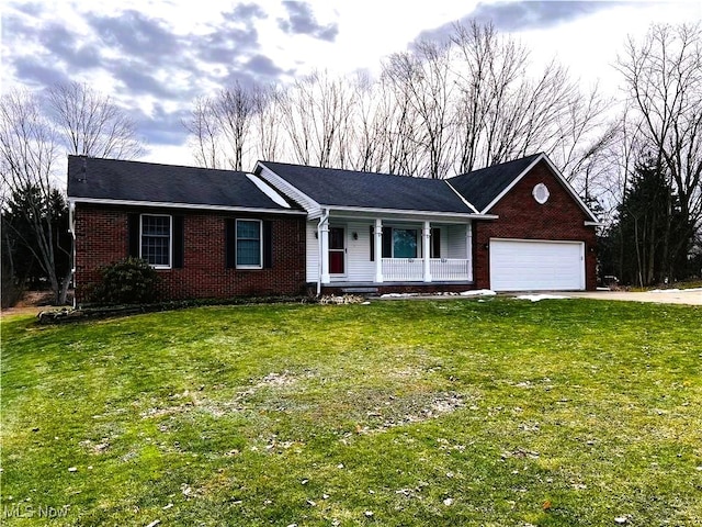 ranch-style home with a porch, a garage, and a front lawn