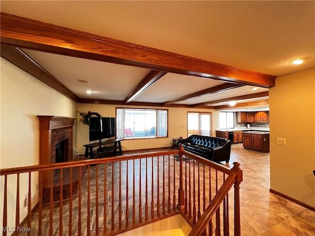 living room featuring beamed ceiling