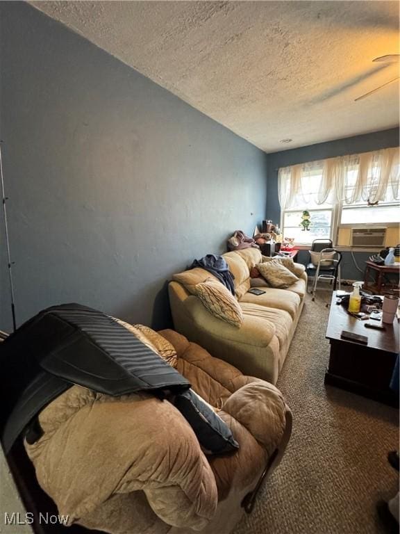 living room with a textured ceiling and carpet flooring