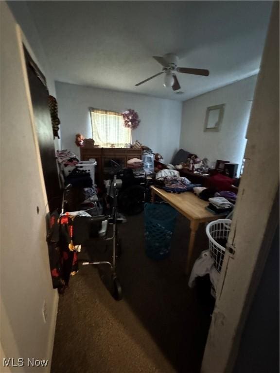 carpeted office featuring ceiling fan