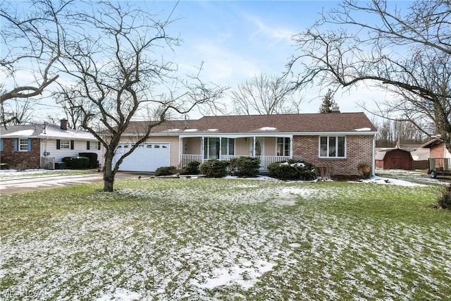 ranch-style home featuring a porch, a garage, and a yard