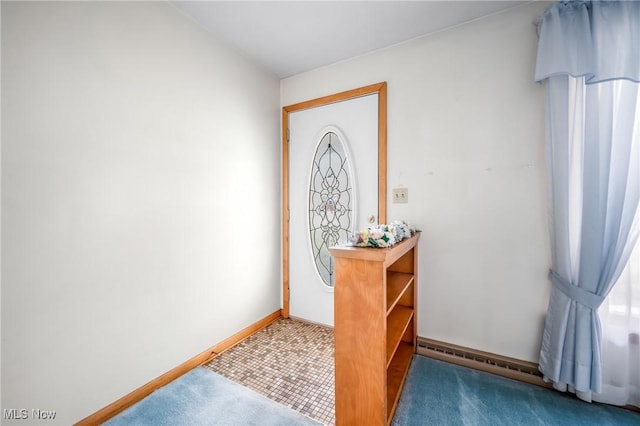 foyer entrance featuring a baseboard radiator and carpet flooring