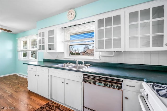 kitchen featuring a baseboard radiator, sink, white cabinets, dark wood-type flooring, and white appliances