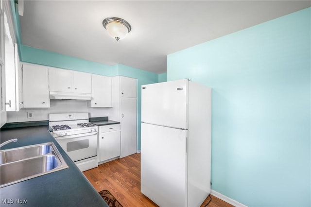 kitchen featuring sink, hardwood / wood-style floors, white cabinets, and white appliances