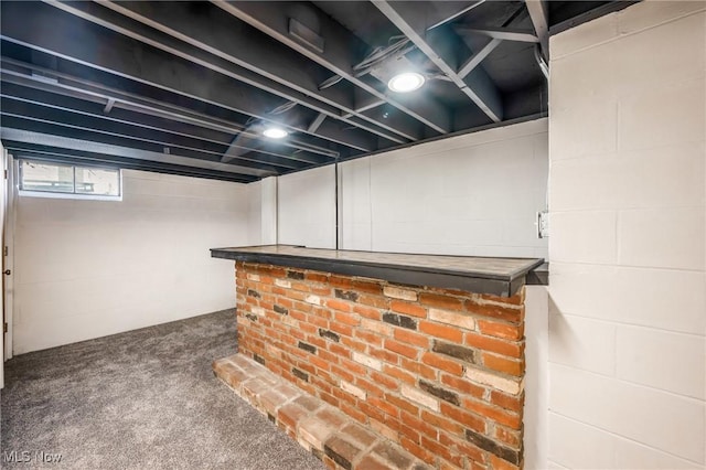 basement featuring carpet floors and bar