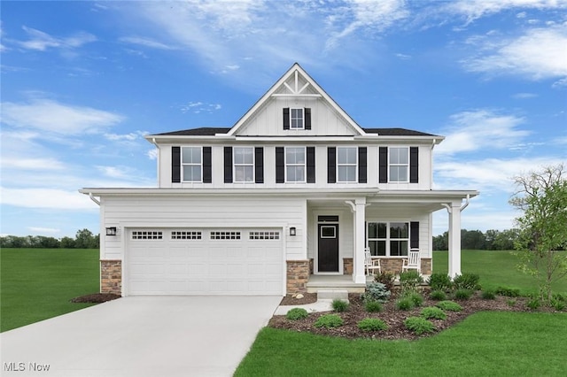 view of front of home featuring a porch, a garage, and a front lawn