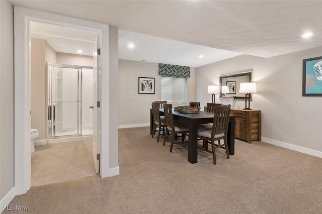 dining room featuring light carpet