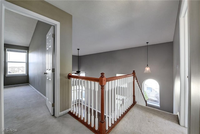 hall with light colored carpet