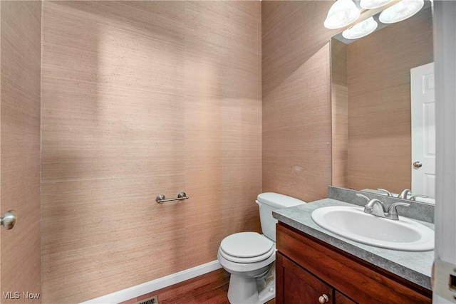 bathroom featuring hardwood / wood-style flooring, vanity, and toilet