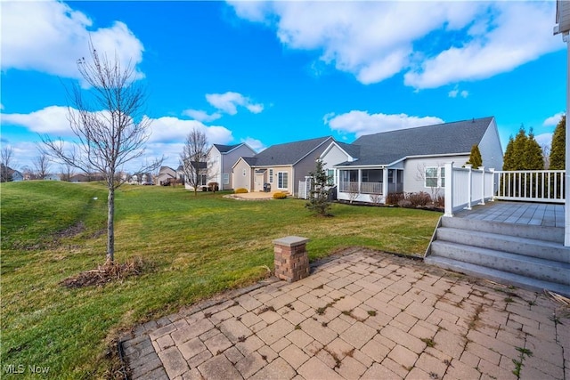 back of house with a patio area and a lawn