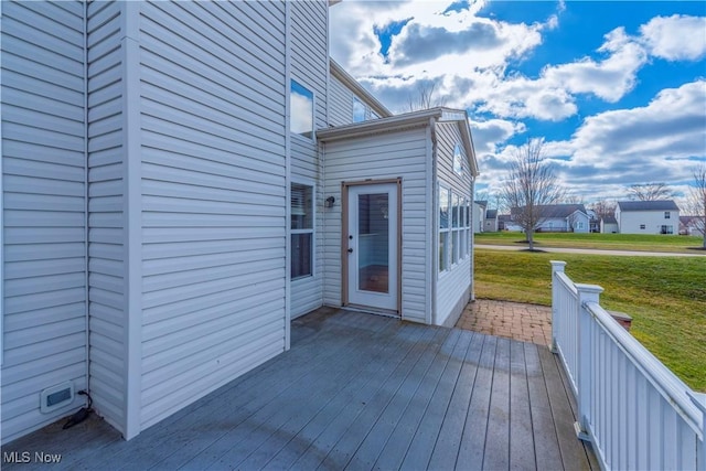 wooden deck with a lawn