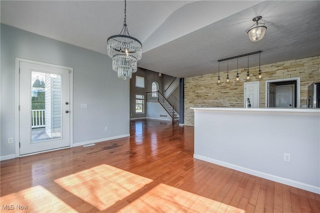 interior space featuring hanging light fixtures, plenty of natural light, and hardwood / wood-style floors