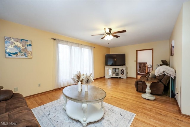 living room with ceiling fan and light hardwood / wood-style floors