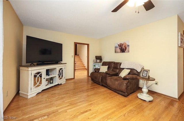 living room with ceiling fan and light hardwood / wood-style floors