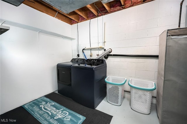 details featuring concrete flooring and washer and dryer