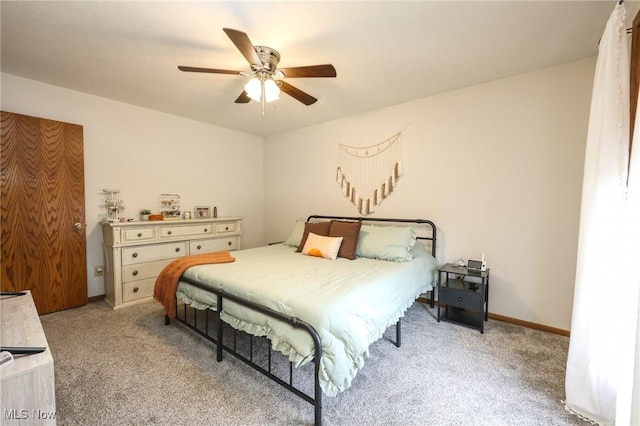 bedroom with ceiling fan and light carpet