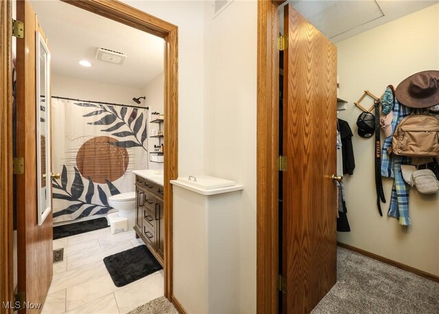 bathroom featuring vanity, toilet, and curtained shower