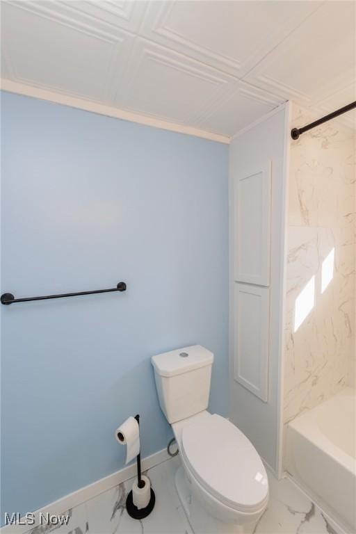 bathroom with tiled shower / bath combo and toilet