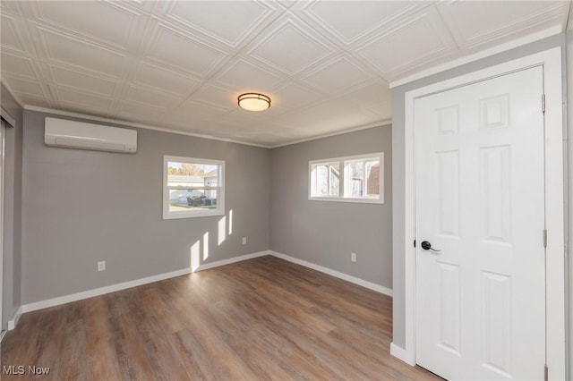 unfurnished bedroom featuring hardwood / wood-style floors and an AC wall unit