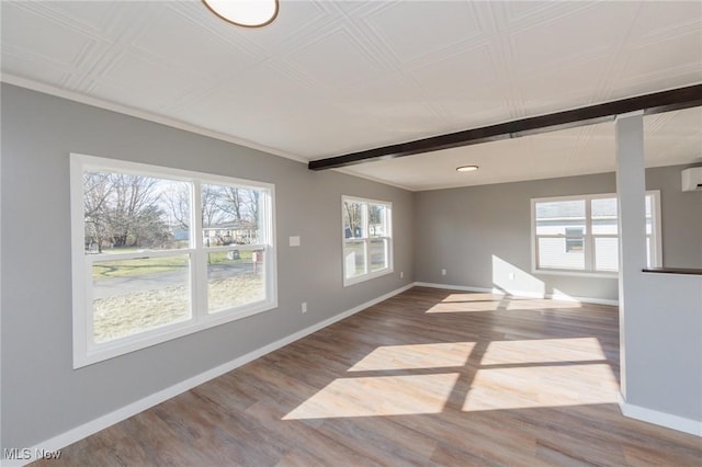 empty room featuring hardwood / wood-style flooring and an AC wall unit