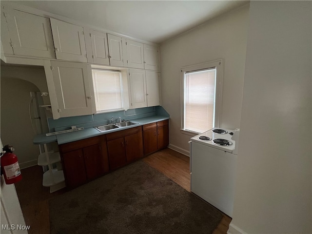 kitchen featuring white electric stove, white cabinetry, sink, and dark wood-type flooring