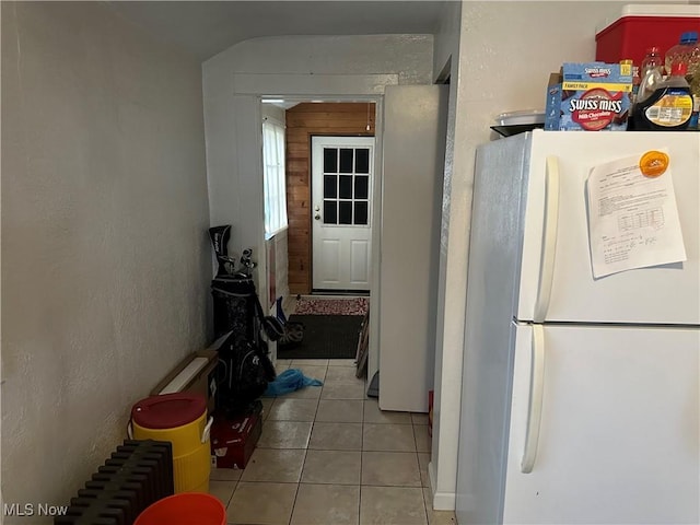 kitchen featuring light tile patterned flooring and white fridge