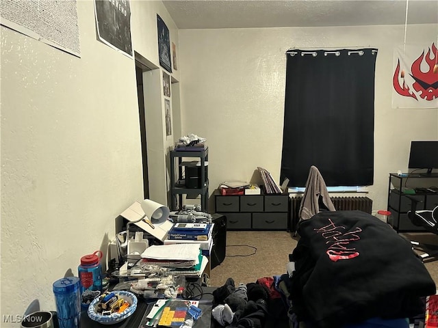 bedroom with a textured ceiling and carpet