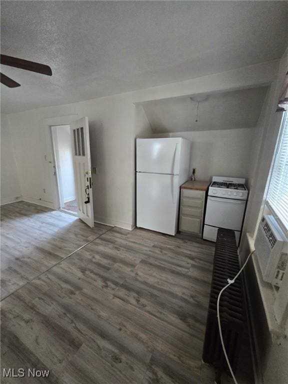 interior space featuring hardwood / wood-style floors, a textured ceiling, a wall mounted air conditioner, and ceiling fan