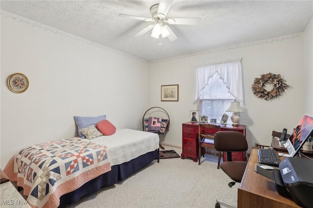 carpeted bedroom with ceiling fan and a textured ceiling