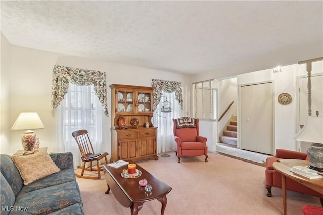 living room with light colored carpet and a textured ceiling