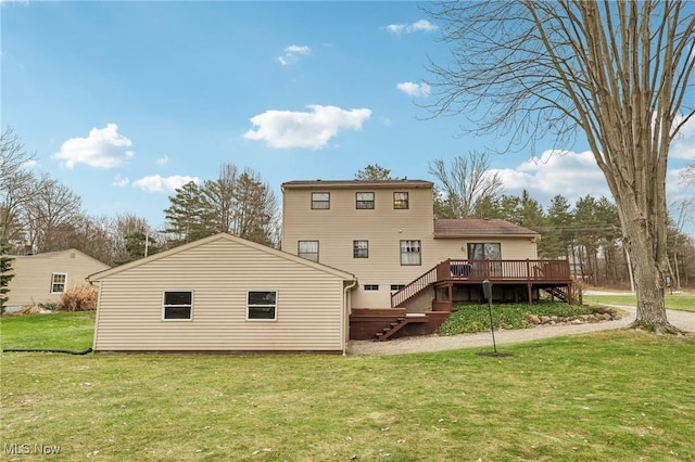 back of house featuring a wooden deck and a yard