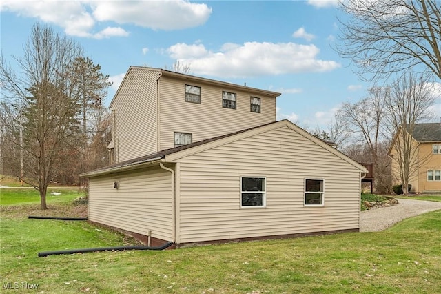 view of property exterior with a yard