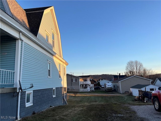 view of property exterior with a lawn