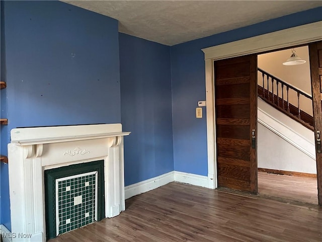 unfurnished living room with hardwood / wood-style flooring